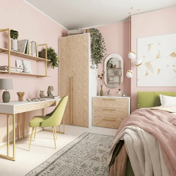 Рабочая зона в розовой детской: письменный стол с золотой рамой, зеленый стул и шкаф-пенал